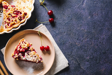 Plate with piece of tasty cherry pie on dark background
