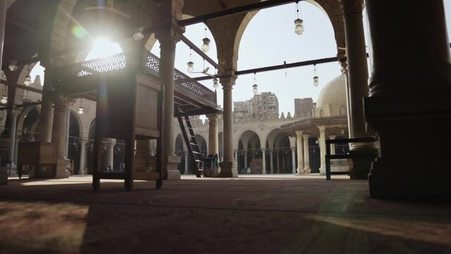 Low tracking shot sideways with sun flare in Mosque Cairo Egypt, slow motion
