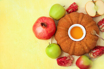 Bread with honey, pomegranate and apples on color background. Rosh hashanah (Jewish New Year) celebration