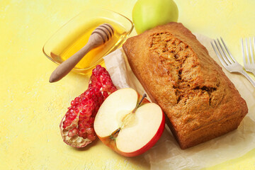 Bread with honey, pomegranate and apples on color background. Rosh hashanah (Jewish New Year) celebration