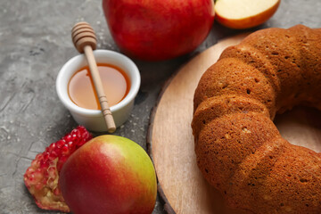 Bread with honey and fruits on grunge background. Rosh hashanah (Jewish New Year) celebration