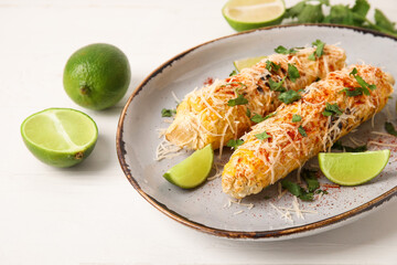 Plate with tasty Elote Mexican Street Corn on white wooden background