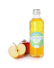 Bottle of natural kombucha tea and fresh apple on white background