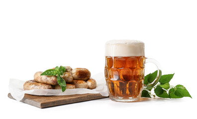 Mug of fresh beer and tasty sausages on white background. Oktoberfest celebration