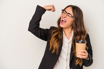Young caucasian business woman holding a takeaway coffee isolated on white background raising fist...