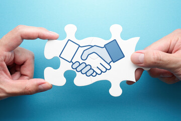 Strategy of business deal. Two hands connecting jigsaw puzzle pieces. Illustration of handshake.