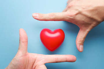 Healthy heart and mental. Heart and hand frame on blue background.