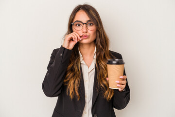 Young caucasian business woman holding a takeaway coffee isolated on white background with fingers on lips keeping a secret.