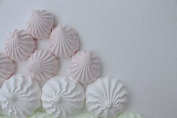 Marshmallows of different sizes, pink and white. White background
