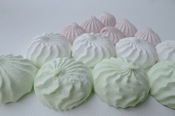 white, pink, green marshmallows on a white background.