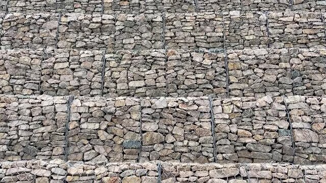 Gabion wall constructed using steel wire mesh basket. Stone walls, protection from backshore erosion. Gabion and rock armour-coastal and waterways protection
