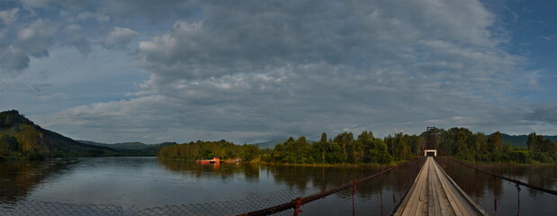Russia. Chita region. A suspension road bridge over the Chikoy River, connecting the district center with the village of Krasny Priisk.
