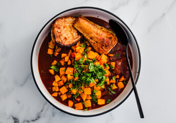 vegan butter chicken curry with pumpkin swede and parsnip topped with fresh homegrown cioriander, healthy plant-based food