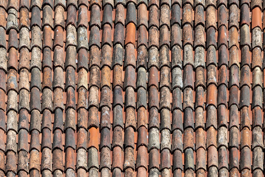 old antique roof tiles at the roof of an old house