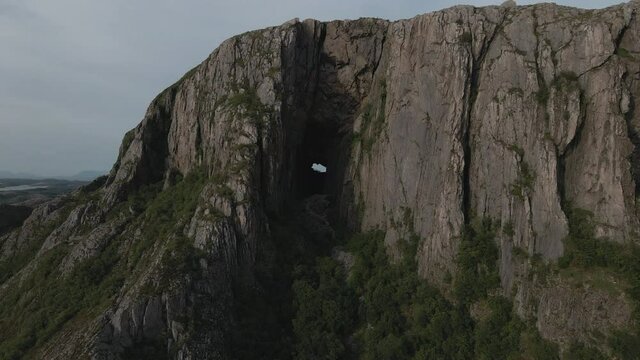 Torghatten With A Natural Tunnel In The Mountain At Norway - aerial drone shot