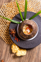 luxury braised stew hashima sweet soup with Chinese herbal in coconut bowl on wood table asian halal menu