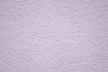 Concrete wall close up. Lilac painted cement grainy textured background.