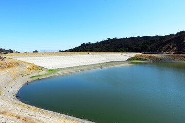 Stevens Creek reservoir at 12 percent capacity in September 2021. Concrete dam of almost dried, low water level Stevens Creek reservoir in San Francisco Bay Area, California.