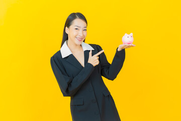 Portrait beautiful young asian woman with piggy bank