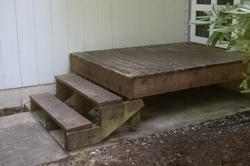 Fototapeta na wymiar old weathered front door landing with cedar steps