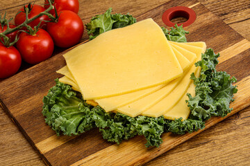 Sliced Gauda cheese over board