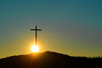Christian cross over beautiful sunset background, concept of spirituality