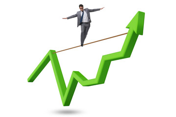 Businessman balancing on tightrope on line chart