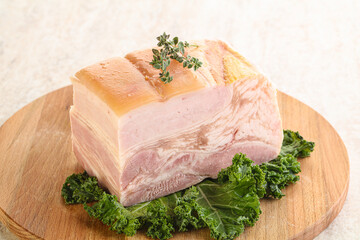 Cut of pork bacon over board