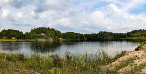 Summer. Sunny. A forest lake among a pine forest.