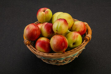 Sweet small nectarines in the basket