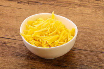 Shredded yellow cheese in the bowl