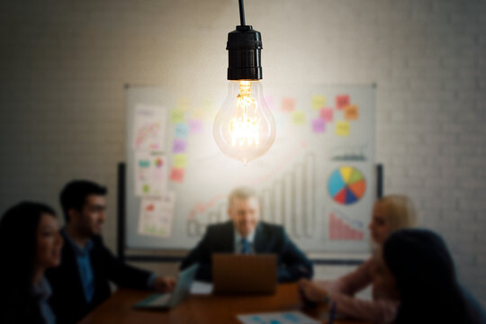 Business people doing meeting with bright bulb