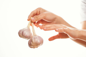 garlic in the hands of cooking ingredients in the kitchen