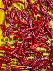 Red chili peppers drying on a tray