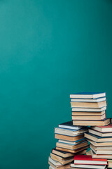 Stacks of books for teaching knowledge college library green background
