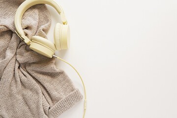 Music, audiobooks, podcast concept, cozy leisure, flat lay composition with headphones, sweater,...