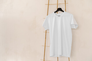 Plain white cotton t-shirt on hanger for your design