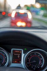 blurred evening traffic jam on the highway in the driver's cabin with a gas tank error, car rush hours city street, vertical.