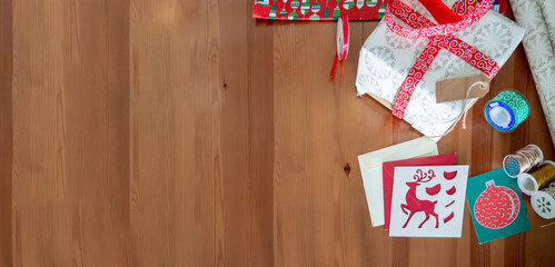 Christmas banner for wrapping Xmas presents with ribbons and Christmas cards. Wood table Christmas...