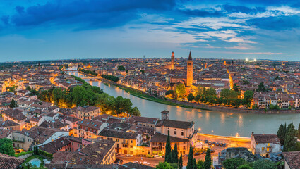 Fototapeta na wymiar Verona Italy, high angle view panorama night city skyline at Adige river
