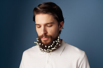 Cheerful bearded man with flowers in his hair modern style