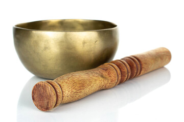 Tibetan singing bowl with wooden stick isolated on white background