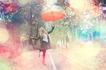 autumn look, sunny day a young girl with an umbrella walks in a yellow park in October