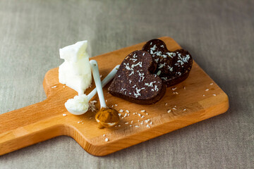 on the table there are handmade chocolates made of coconut oil, coconut chips and cocoa. dessert according to the recipe of proper nutrition.