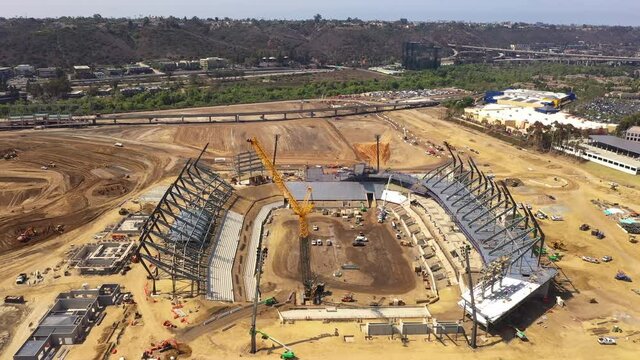 Stadium construction with crane. Drone forward.