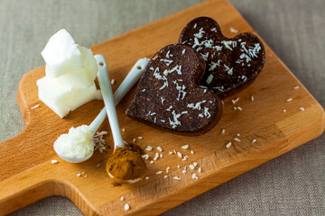 on the table there are handmade chocolates made of coconut oil, coconut chips and cocoa. dessert according to the recipe of proper nutrition.