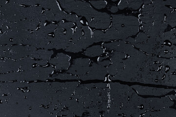 Water on dark stone surface