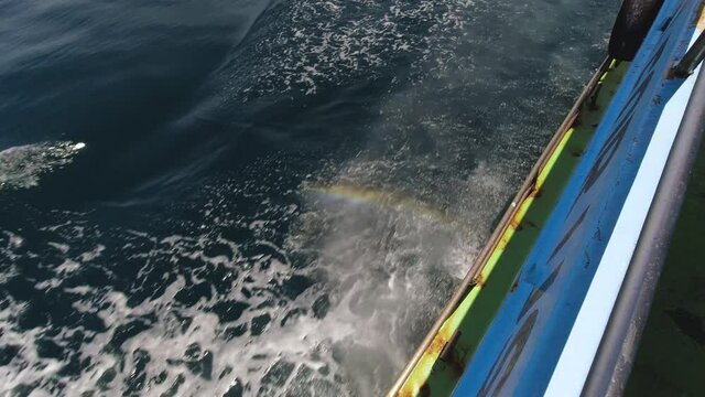 Water Spray From a Ferry Boat with a Rainbow Crossing to Koh Phi Phi Islands from Krabi in Thailand.