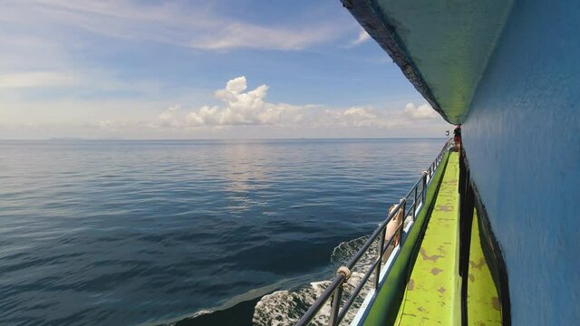 The Side of a Ferry with Open Waters and Beautiful Blue Skies Over the Horizon Heading to Koh Phi Phi Islands from Krabi in Thailand.