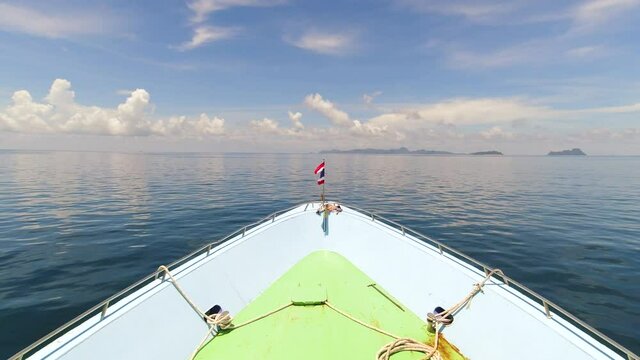 Thai Flag on the Bow of the Ferry Boat Crossing to Koh Phi Phi from Krabi, Thailand with Beautiful Blue Skies